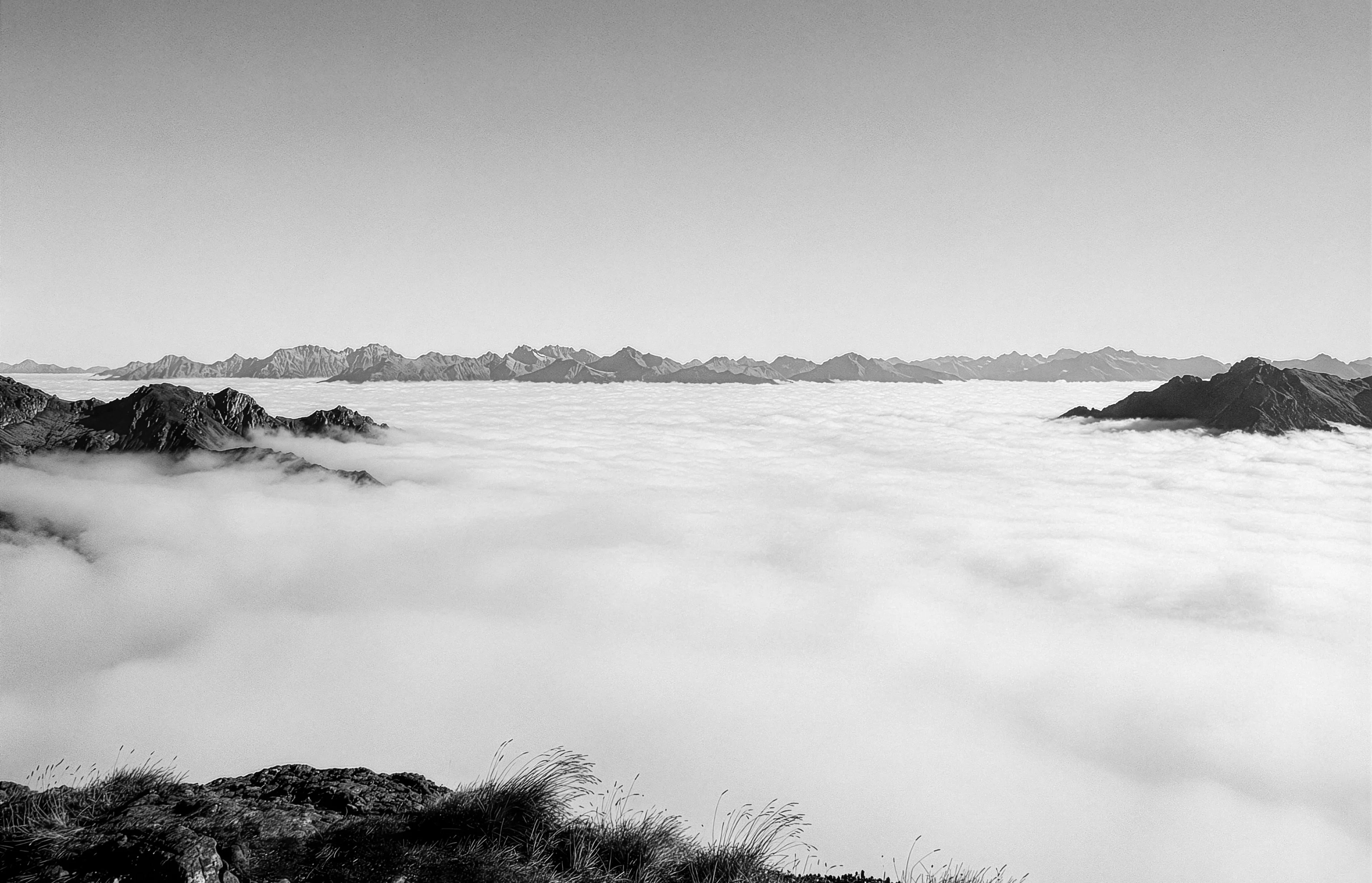 Mountain peaks rising above a sea of fog